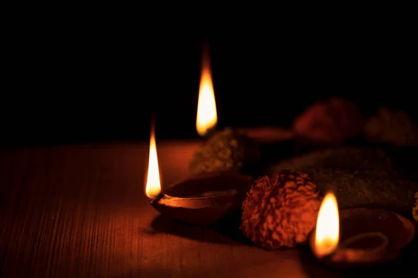 Three Decorative Burning Diya with Marigold Flowers — стоковое фото