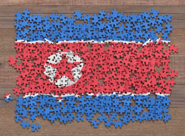 Flag of the North Korea in disorganized pieces of a puzzle.