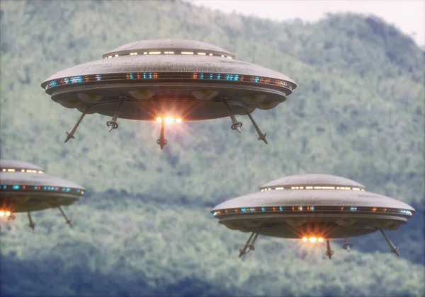 Three unidentified flying objects over a forest with trees and mountains behind.