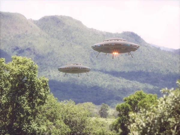Two unidentified flying objects over a forest with trees and mountains behind.