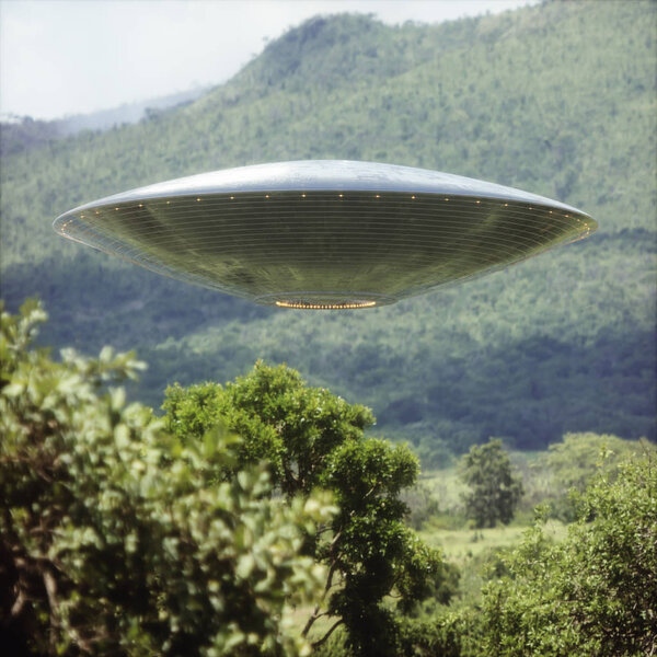 Unidentified flying object over a forest with trees and mountains behind.