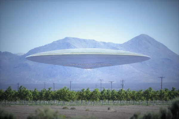 Unidentified flying object - UFO, flying over plantations in desert place with mountains behind.