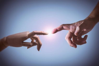 Bir insan eli ve menteşeli ahşap bir elin fotoğrafı. Adem 'in yaratılışının kavramsal resmi.