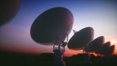 Dünya 'dan iletişim ve sinyal alabilmek için büyük uydu anteni antenleri. Gün batımında uzayda radyo sinyali arayan gözlemevi.