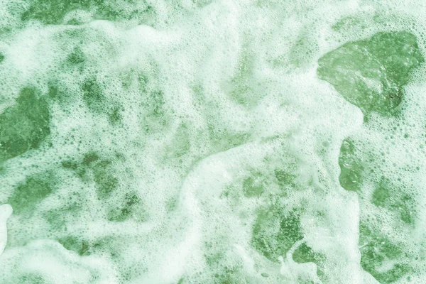 Deniz suyunun turkuaz köpüklü yüzeyi, üst görünüm.