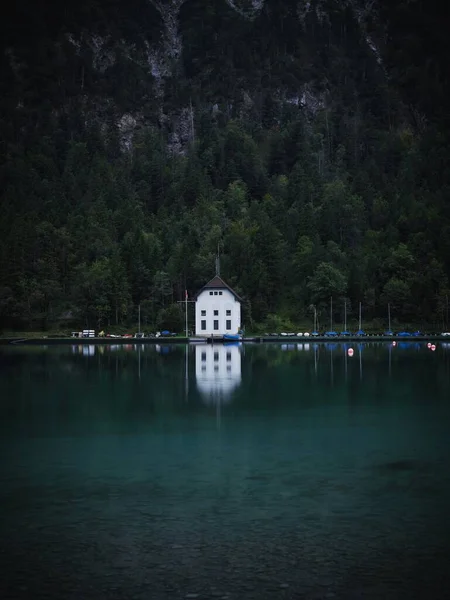 Reflection of house in mountain lake Plansee Tyrol Austria — Stock Photo, Image