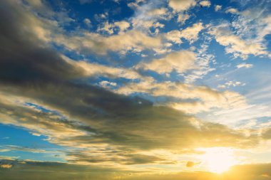 Dramadik Sunset Sky gökyüzünde bulutlar aracılığıyla güneşin mavi ve turuncu ışık