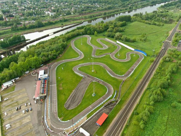 High altitude flight over the sports car race track on the river bank. look from top to down