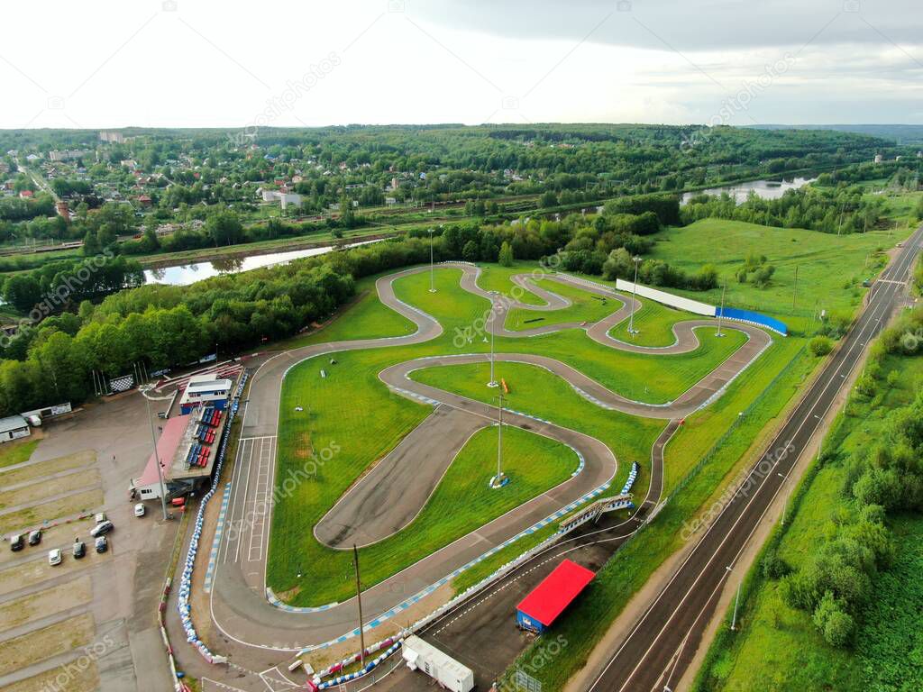High altitude flight over the sports car race track on the river bank. look from top to down