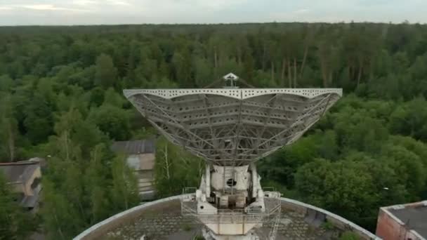 空中からの眺めは緑の森を背景にした電波望遠鏡の大きな宇宙アンテナです 宇宙通信装置 — ストック動画