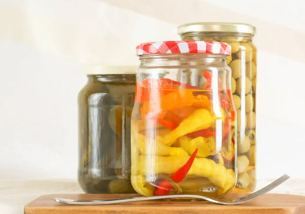 Three Glass Jars Canned Peppers Olives Cucumbers Fork — Stock Photo, Image