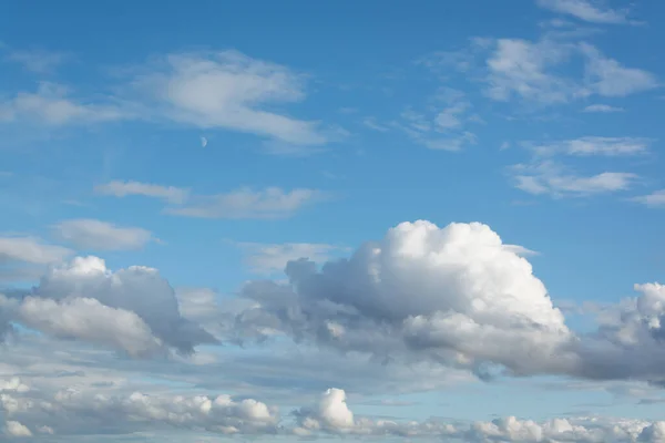 Background with blue sky, clouds and moon