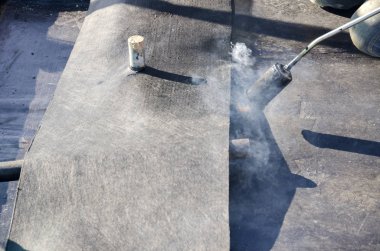 Bitümlü kılıf ile bir binanın bir çatı yenileme sırasında inşaat çalışmaları