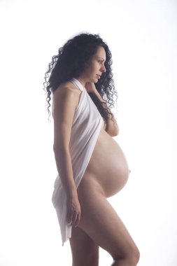 Bir görünür dansöz ve eşarp beyaz bir arka plan üzerinde çıplak hamile bir genç kadın portresi.