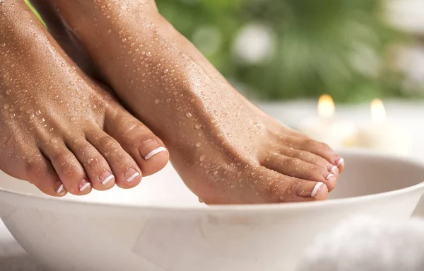 Foot spa on a tropical green leaves background — Stock Photo, Image