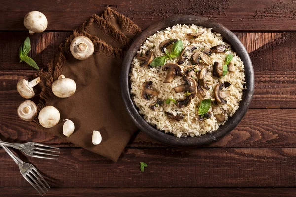 Cooked white rice with mushroomsin a bowl on wooden background. — Stock Photo, Image