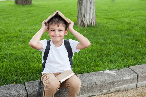 Boy White Shirt Backpack Sits Stack Books His Head Back — Stock Photo, Image