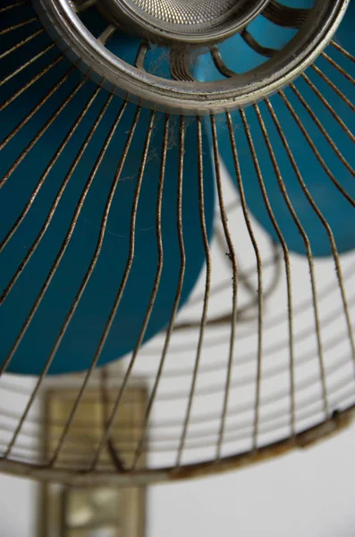 Vintage white stand fan with blue blades