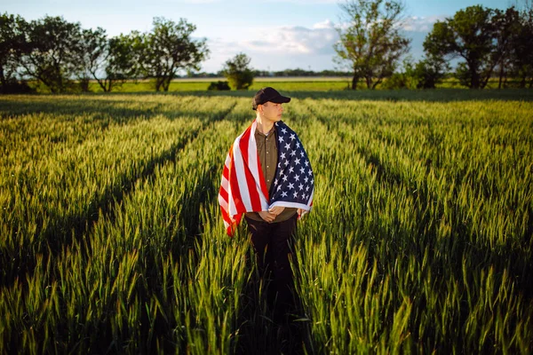 Young Man Wearing Green Shirt Cap Stands Wrapped American Flag — Stock Photo, Image