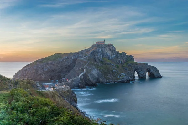 Church on a rock castle above the sea, under a beautiful sunset.