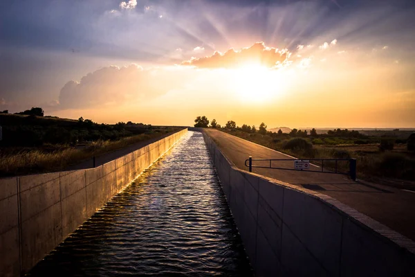 sunset on the new channel Segarra - Garrigues, as it passes through the town of Sant Marti de Mald.