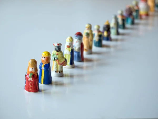 Row of figures of the Three Kings for the Christmas cake. White background and selective focus. Christmas concept.