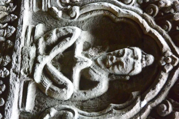 Kamenný basreliéf modlícího se mnicha vytesaného do zdi chrámu — Stock fotografie