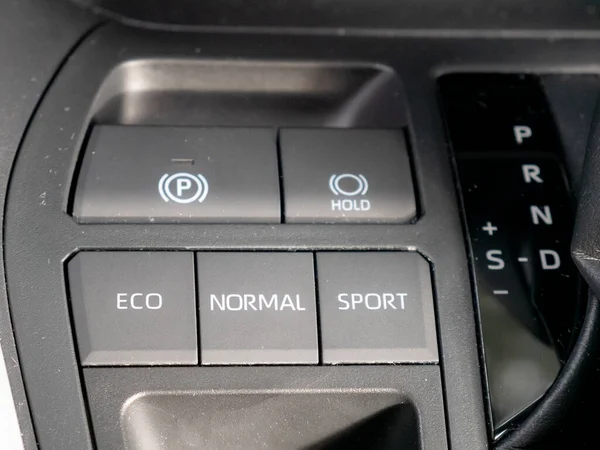 Buttons on the dashboard of a hybrid vehicle indicating the driving modes and the letters of the hybrid transmission of the gear lever