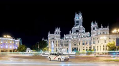 Madrid 4k gece zaman çizelgesinde Plaza de Cibeles 'i, Puerta de Alcala' yı, belediye binasını, La casa de America 'yı ve araba ve otobüs trafiğini görebiliyoruz.