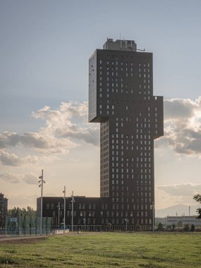 Kastilya ve Leon 'un en yüksek ikinci binası olan Rosaleda Kulesi (Kastilya ve Leon' un en yüksek ikinci binası), günbatımında güneşin aydınlattığı Parque del Oeste 'deki ağaçlar arasında yer alır.