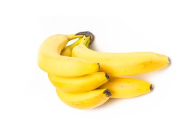 Beyaz bir zemin üzerinde olgun sarı muzlar.