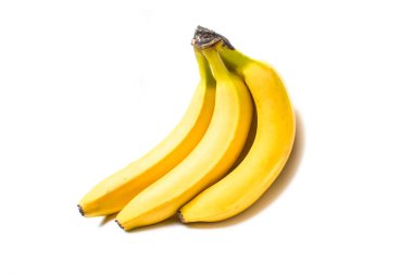 Beyaz bir zemin üzerinde olgun sarı muzlar.