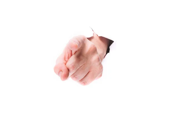 Mužská ruka ukazující prst skrz díru v papíru na bílém pozadí izolátu. zavřít, kopírovat mezeru. — Stock fotografie