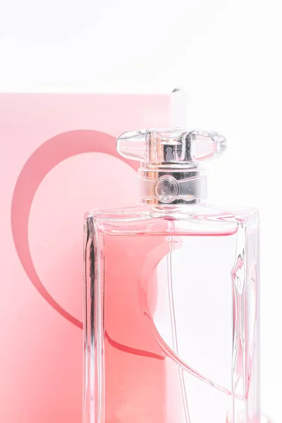 Pink perfume bottle in back box on white background copy space. bot view, vertical orientation, close up, mockup — Stock Photo, Image