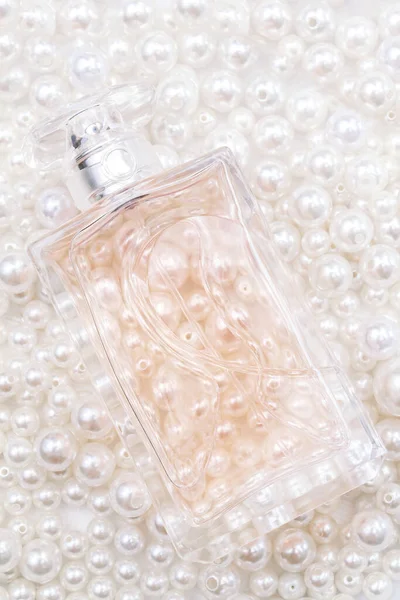 Perfume bottles on pearl beads — Stock Photo, Image