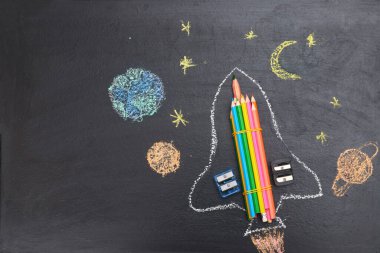 Okul tahtasındaki kalemlerden yapılmış bir roketle okula döndüm.