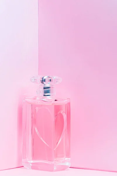 Pink perfume bottle on pink background copy space. bot view, vertical orientation, mock up — Stock Photo, Image