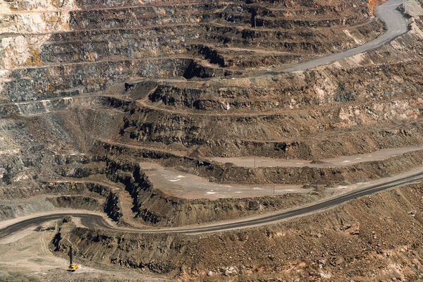 an iron ore quarry, a road of stepped terraced relief, Mining industry. Mine and quarry equipment.
