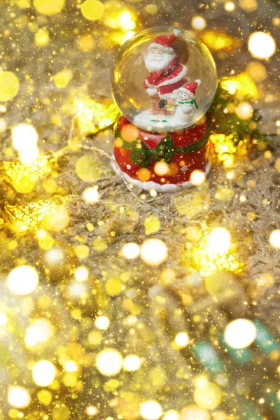 Postcard ,christmas ball with snow and santa claus and toys, bokeh, flatley, copy space — Stock Photo, Image
