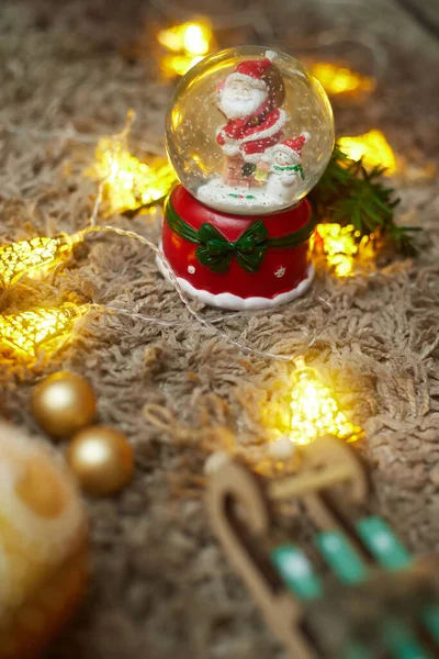 Christmas ball with snow and santa claus and toys, bokeh, flatley, copy space — Stock Photo, Image