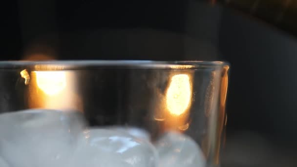 Hälls i ett glas med is från en flaska, bartender, närbild — Stockvideo