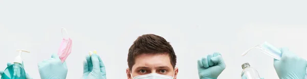 Coronavirus concept banner, guy in mask, hands in gloves holds medical elements on white background — Stock Photo, Image