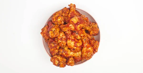 Buffalo chicken wings in a plate on a white background, copy space — Stock Photo, Image