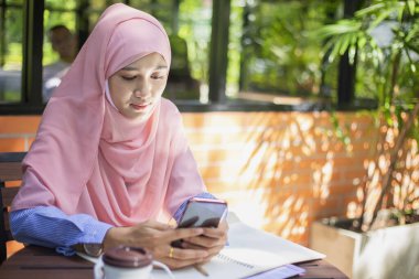 Zarif Müslüman ofis çalışanı şirketin pazar analizi hakkında belgeler ve raporlar tutuyor ve bunları ticarete hazırlamak için çalışma planlarını araştırıyor. Yaşam Tarzı Konsepti.