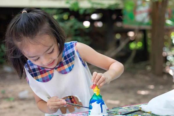 Cute little girl is learning outside the classroom happily with beautiful nature And a bright smile