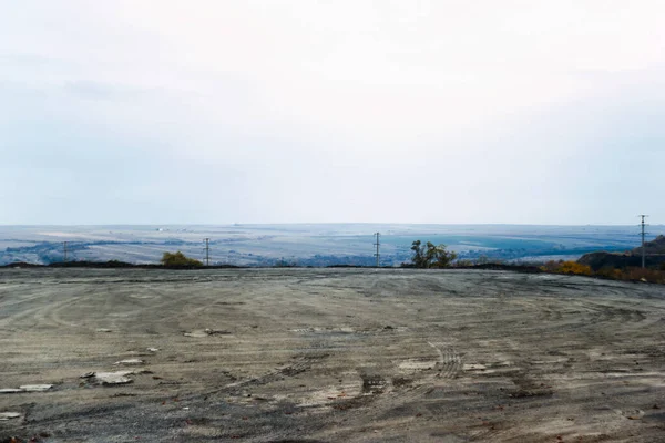 Preparation of a plot of land for construction. A beautiful horizon shrouded in blue. Cloudy spring day