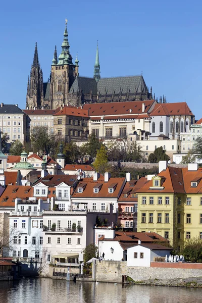 Colorful autumn Prague gothic Castle with the Lesser Town above River Vltava in the sunny Day, Czech Republic