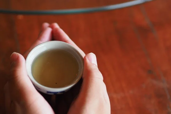 Pick up The Hot tea cup in chinese restaurant