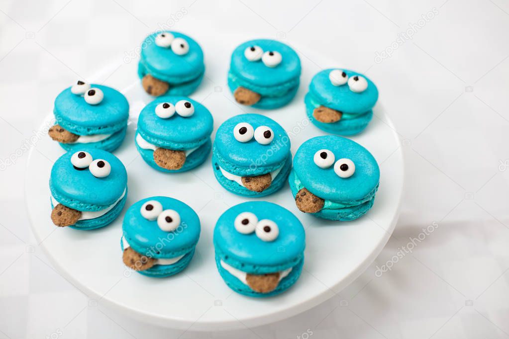 Cookie Monster macarons on white background