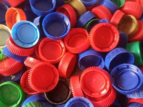 multicolored plastic bottle caps placer  and background
